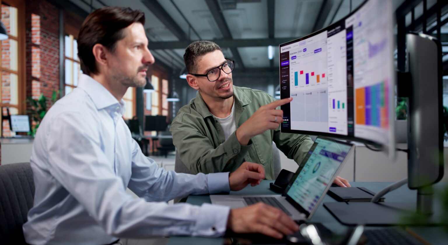 Purchasing team reviewing auto parts price lists on screen